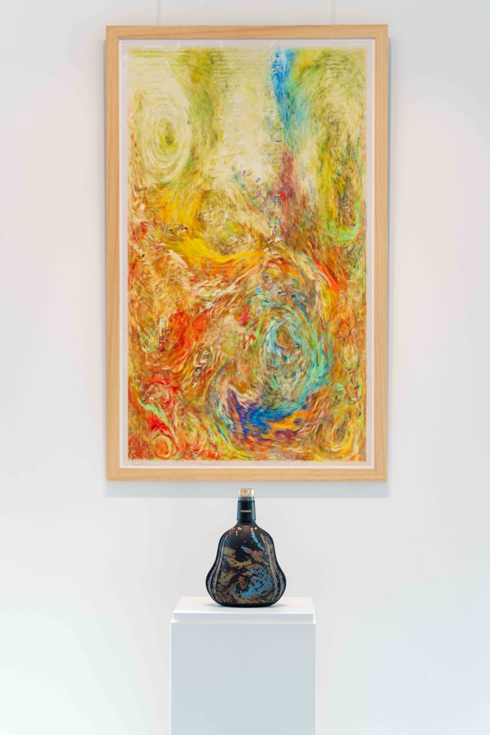 Framed generative artwork with painted Hennessy X.O. bottle displayed below